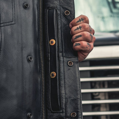 A man with a First Manufacturing Sharp Shooter Motorcycle Leather Vest and biker style.
