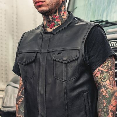 A man with tattoos sporting a First Manufacturing Sharp Shooter Motorcycle Leather Vest.