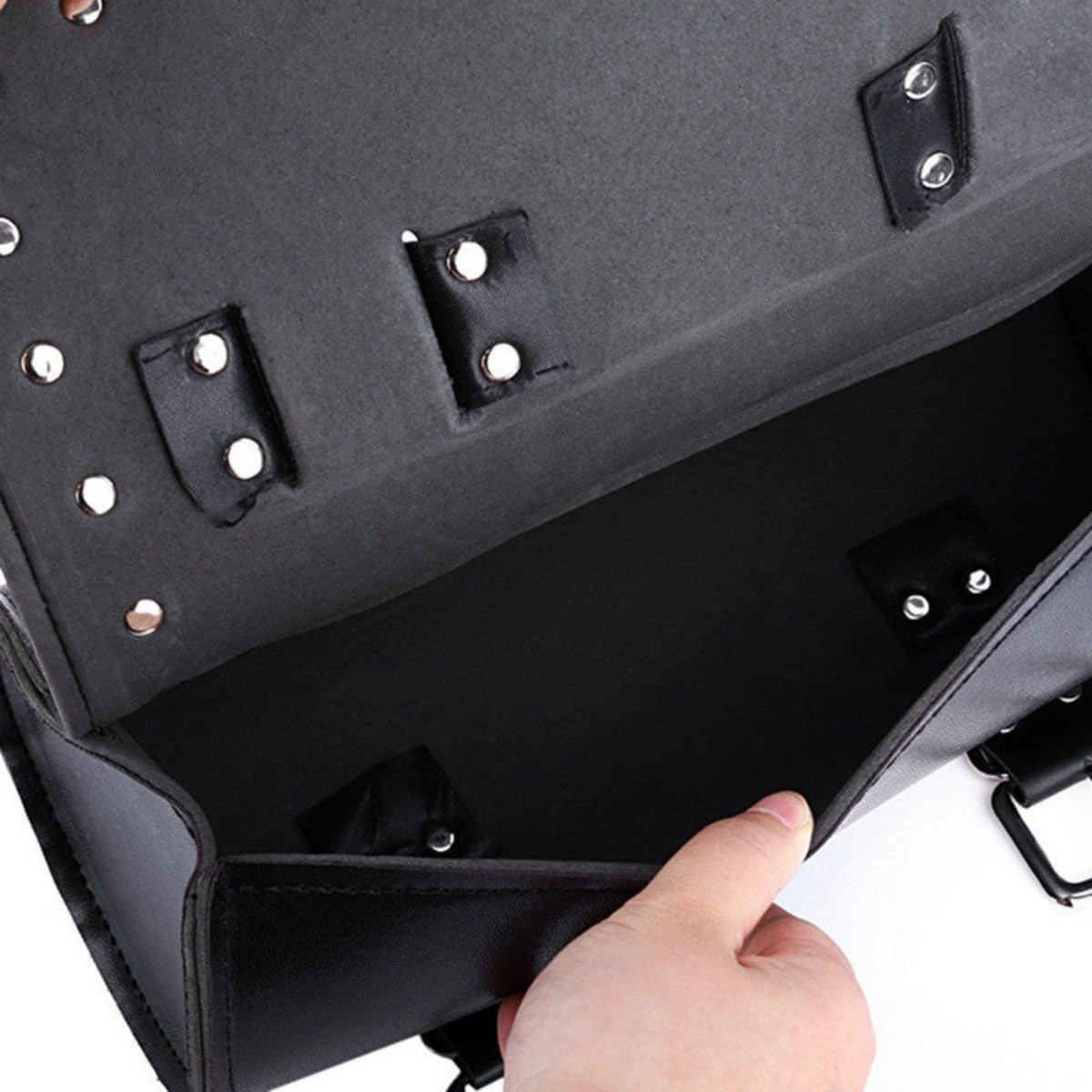 A person is holding a Motorcycle Leather Duffle Roll Bag black leather briefcase.