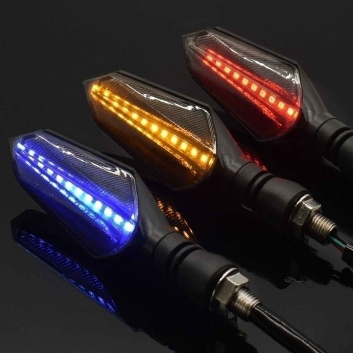 Four Universal Motorcycle LED Turn Signal Sequential Flow on a black surface, enhancing safety with their turn signal functionality.