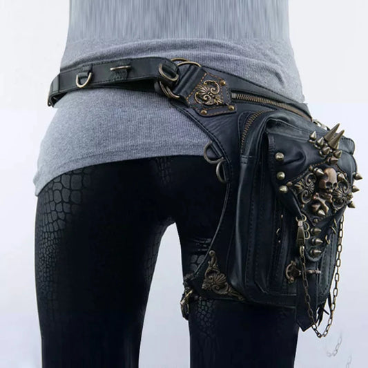 A person is wearing black snake-patterned leggings and a gray sweater, with a Women's Gothic Waist/Hip/Body Fanny Bag featuring spacious compartments, spikes, chains, and gothic-inspired design embellishments.