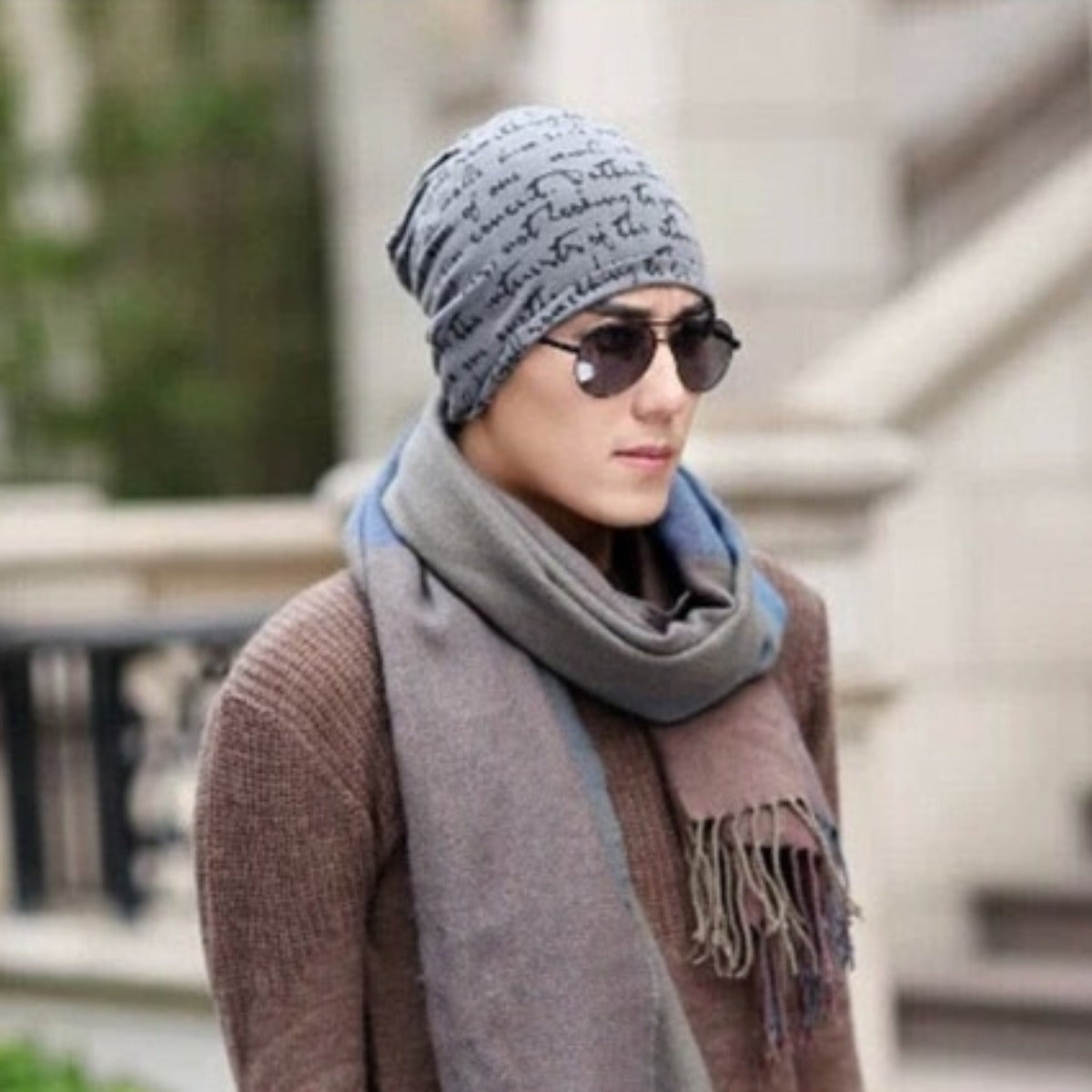 A fashionable man wearing a Fashionable Printed Beanie Hat and sunglasses.