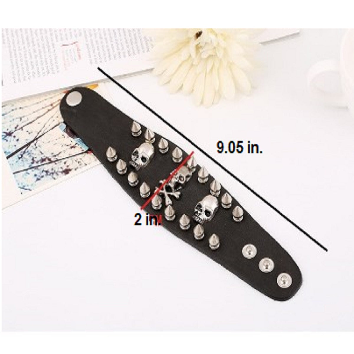 A black leather Skull & Bones Biker Wristbands with skulls and spikes.