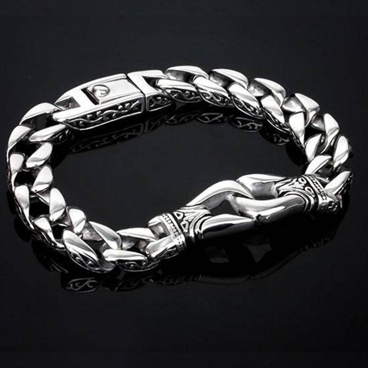A modern medieval fantasy jewelry piece, this Stainless Steel Vintage Charm Bracelet for Bikers features intricate designs on the clasp and links, set against a black background.