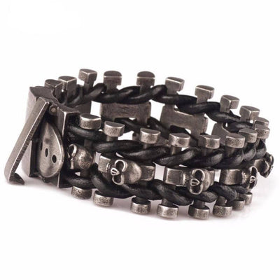 A Skeleton Chain Buckle Bracelet featuring skulls on a sleek black leather band.