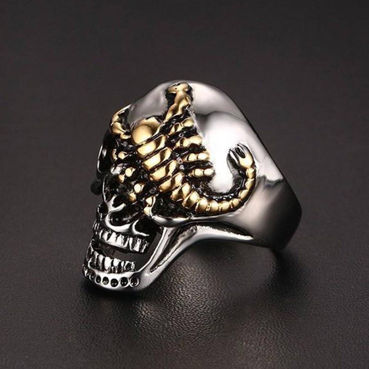 The Stainless Steel Punk Rock Silver Skull & Gold Scorpion Ring showcases a striking silver skull design adorned with a golden scorpion accent atop it, all set against a black background. This limited edition piece is ideal for those seeking to make unique and bold style statements.