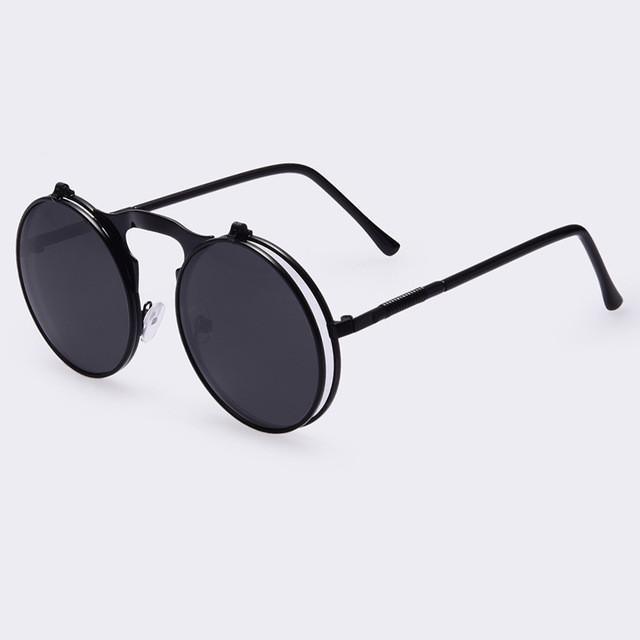 A pair of Vintage Motorcycle Glasses with a black frame and black lenses.