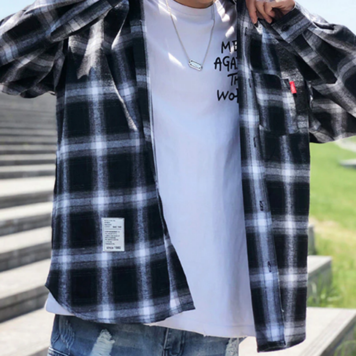 A man wearing a Men's Classic Plaid Flannel Shirt, Black/White, reminiscent of the classic American Legend Ride.