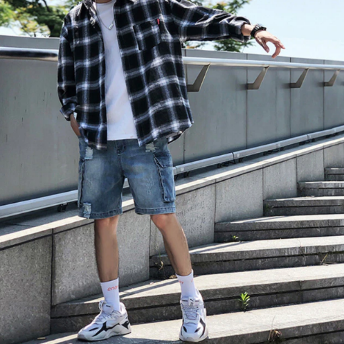 A young man wearing a Men's Classic Plaid Flannel Shirt, Black/White.