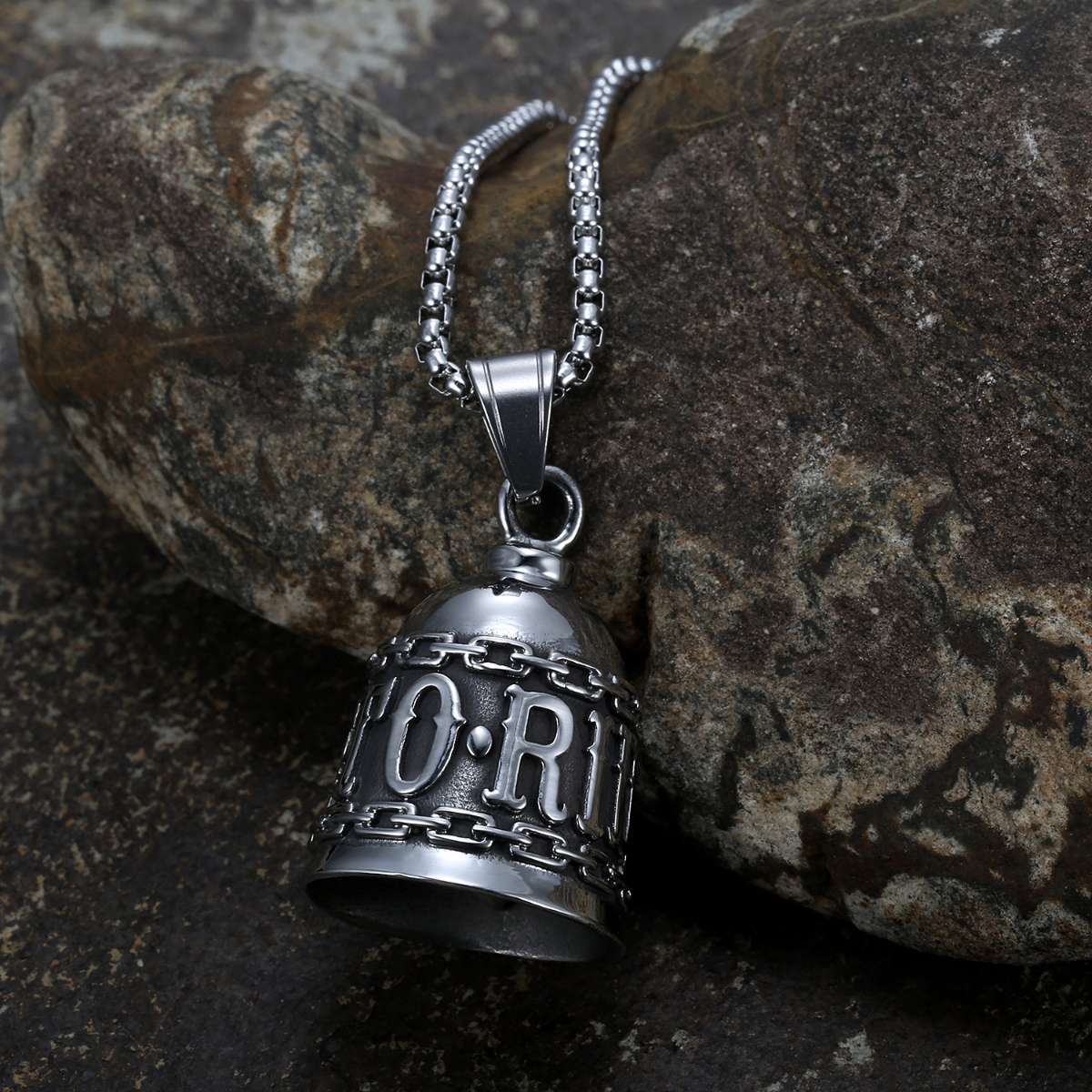 A Live to Ride Gremlin Bell with the word "orr" on it is sitting on a rock, serving as a Guardian Bell.