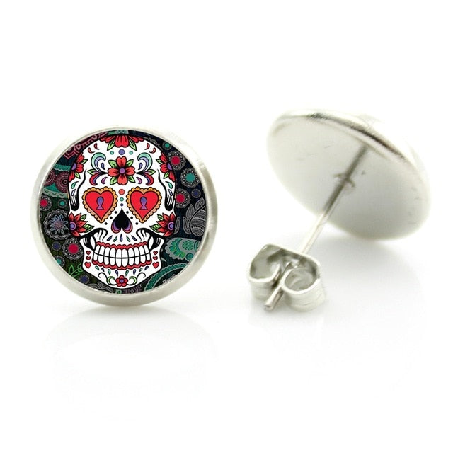 These Sugar Skull Stud Earrings are showcased on a white background, highlighting their unique and intricate design. Perfect for any occasion, these captivating jewelry pieces añd a touch of boldness to your attire.