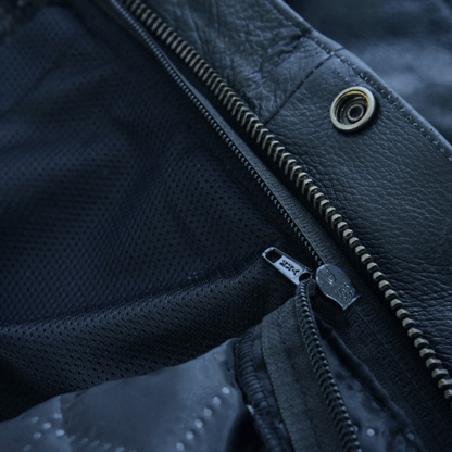 Close-up of the Vance Zip-Out Insulation Pant Style Motorcycle Leather Chaps, showcasing two zippers on black fabric and leather material reminiscent of classic chaps. One zipper is partially open, revealing a mesh lining beneath.