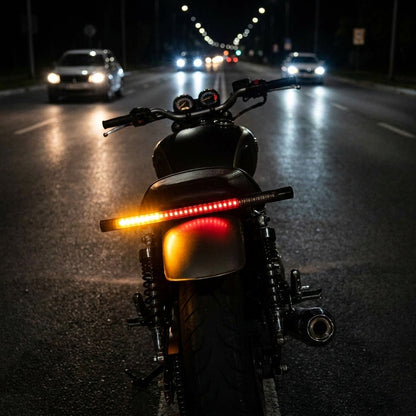 Motorcycle LED light bar showing an amber turn signal at night