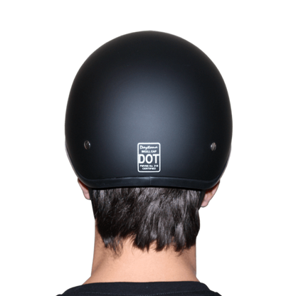 Rear view of a person wearing a Daytona D.O.T Skull Cap - w/Lovesee Helmet with DOT certification label, featuring a slim line design and moisture-wicking fabric for added comfort.
