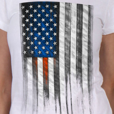 The Hot Leathers Ladies Short Sleeve Heartbeat Flag T-Shirt features a distressed black and white American flag design, enhanced with bold blue and red stripes. Each shirt is carefully screen printed and proudly made in the USA.