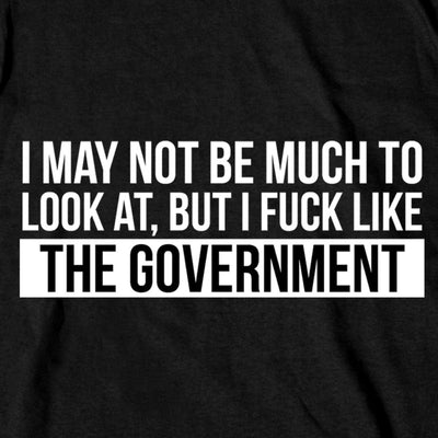 A black heavyweight cotton shirt boldly features the text: "I may not be much to look at, but I [expletive] like the government," produced by Hot Leathers in the USA.