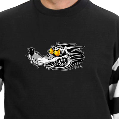 A person wearing the Hot Leathers Men's Race Wolf Striped Jersey Long Sleeve Shirt, a heavyweight black shirt adorned with a stylized, snarling wolf graphic featuring exaggerated yellow eyes on the chest. The cotton knit fabric and reinforced stitching ensure durability and comfort.