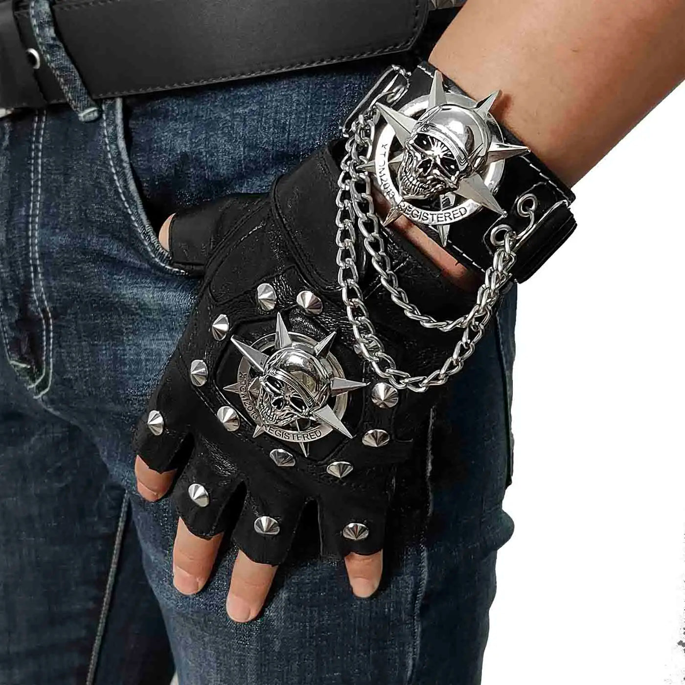 A man sporting Men's Skull Steampunk Biker Leather Gloves adorned with chains and studs, channeling a hint of punk rock attitude.