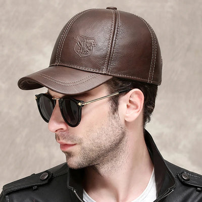 A man wearing an ALR™ Genuine Leather Eagle Baseball Cap, sunglasses, and a black jacket.