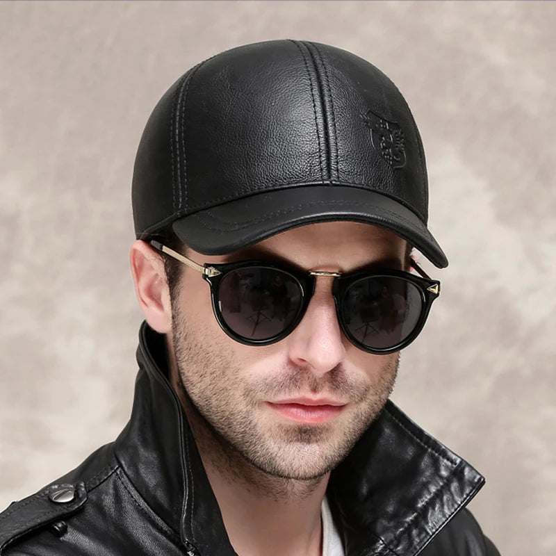 A person stylishly dons an ALR™ Genuine Leather Eagle Baseball Cap, paired with sleek sunglasses and a matching leather jacket.