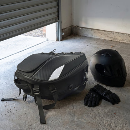ALR motorcycle tail bag on a garage floor beside a helmet and gloves