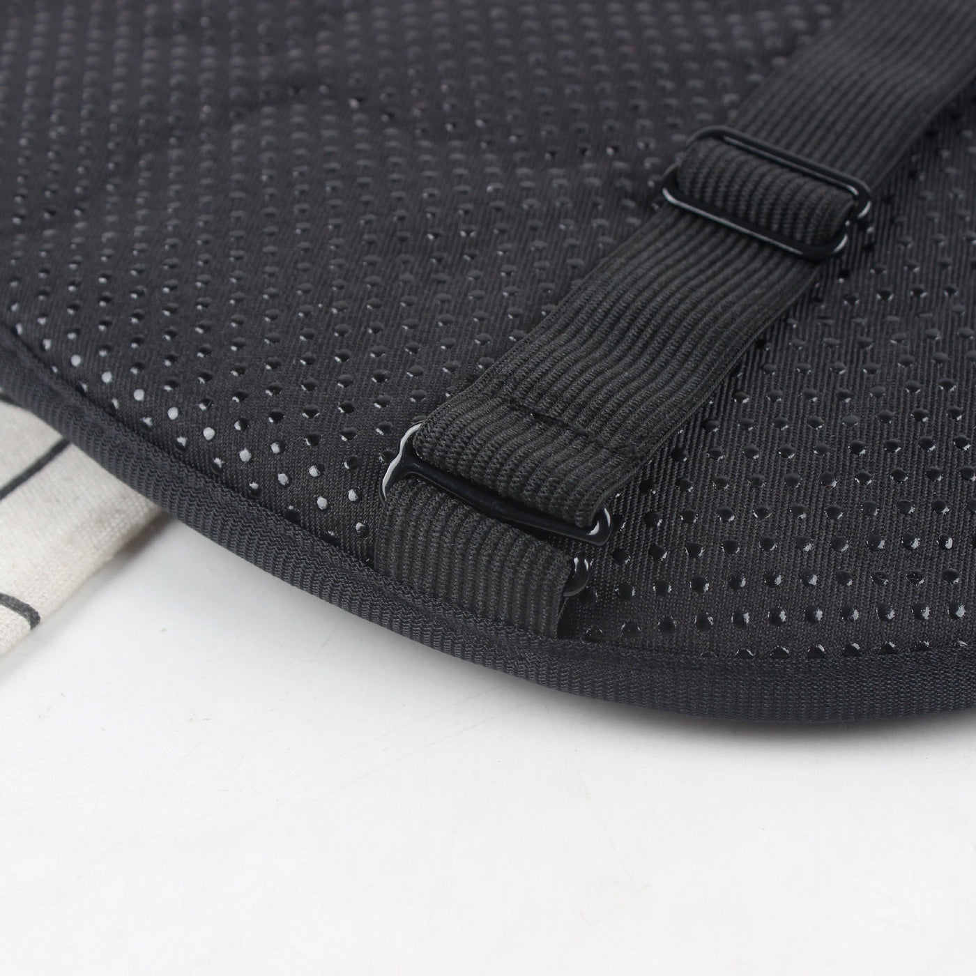 A black mesh bag with a strap on it designed for shock absorption, the Motorcycle Seat Cushion Pad.