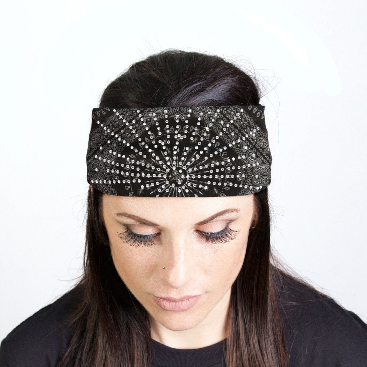 A woman donning a Hot Leathers Bandana Headband Wraps w/Rhinestones, exuding biker style with a touch of sparkle.