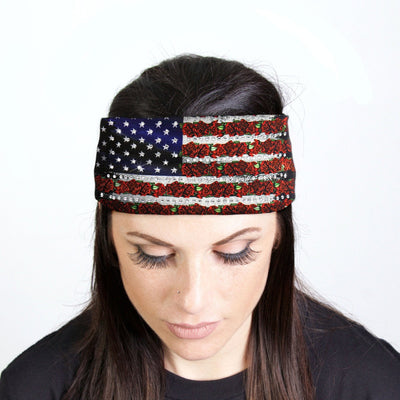 A woman wearing a sparkling Hot Leathers Flag Rose Bandana Headband adorned with rhinestone crystals, giving it a biker style flair.