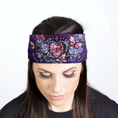 A woman wearing a Hot Leathers Heart Lock Bandana Headband Wraps w/Rhinestones, adding a touch of sparkle to her biker-style look.