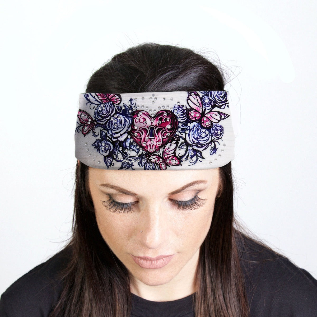A woman adding sparkle to her biker style outfit with a Hot Leathers Heart Lock Bandana Headband Wraps w/Rhinestones, White featuring a flower design.