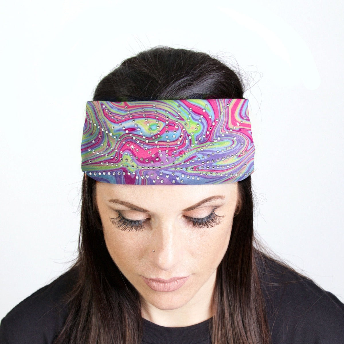 A woman wearing a Hot Leathers Rainbow Swirl Bandana Headband Wraps w/Rhinestones, adding a touch of sparkle to her biker style ensemble.