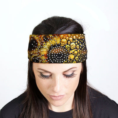 A woman adorned with the Hot Leathers Sunflower Skulls Bandana Headband Wraps w/Rhinestones, exuding biker style.
