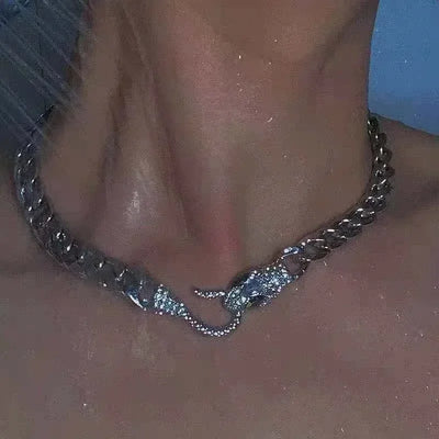 Wearing the ALR™ Vintage Punk Viper Necklace, with its bold snake-shaped clasp, a person captures an edgy allure as it glistens under water droplets.