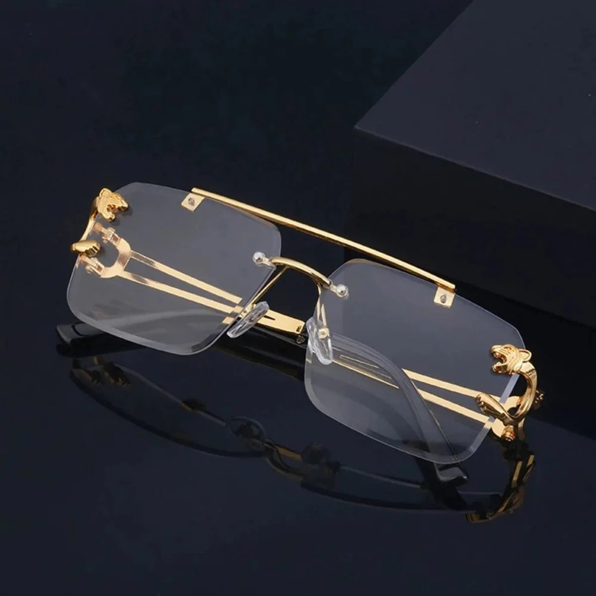A pair of Retro Rimless Steampunk UV400 sunglasses on a black background.