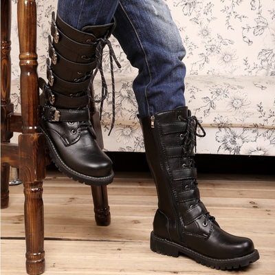 A man enjoying the comfortable fit of his Mid-Calf Leather Motorcycle Riding Boots while confidently resting on a chair.