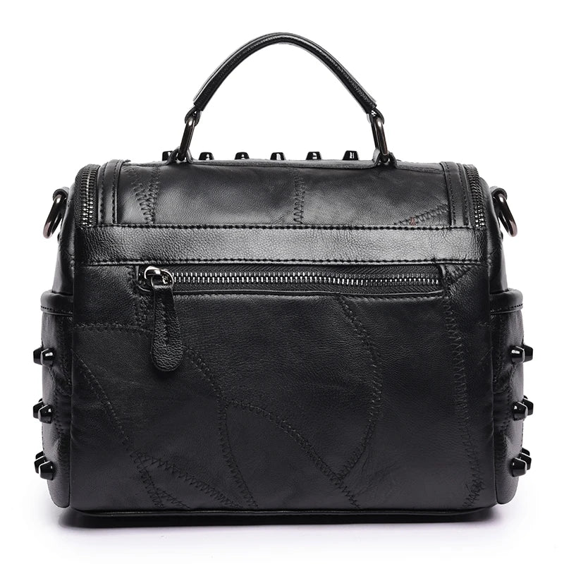 The ALR™ Luxury Women’s Genuine Leather Bag is a high-end black handbag made from premium sheepskin leather, featuring a top handle, decorative stitching, front zipper pocket, metal stud accents, and designer-level craftsmanship.