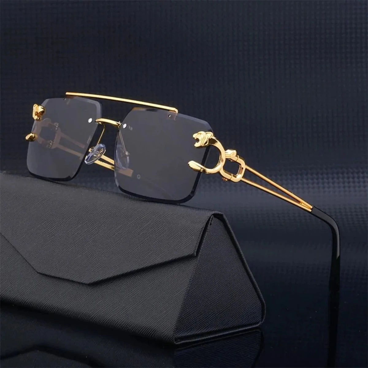 A pair of Retro Rimless Steampunk UV400 Sunglasses with gold rims on a black background.
