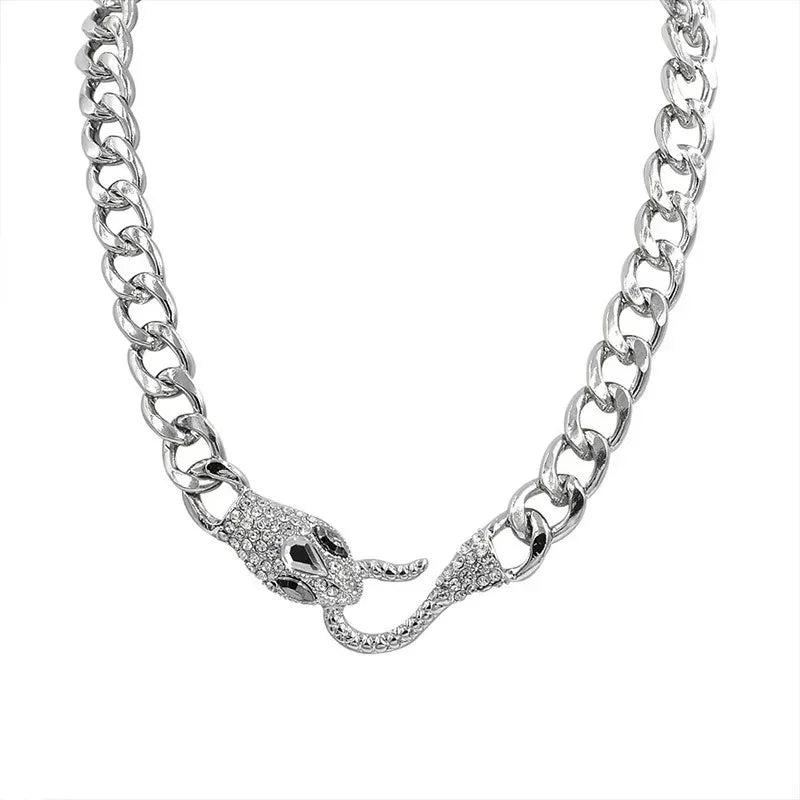 The ALR™ Vintage Punk Viper Necklace boasts a chunky silver chain with a clasp featuring two intertwined snake heads, embellished with small crystals.