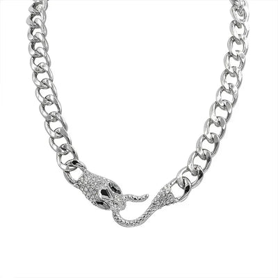 The ALR™ Vintage Punk Viper Necklace boasts a chunky silver chain with a clasp featuring two intertwined snake heads, embellished with small crystals.