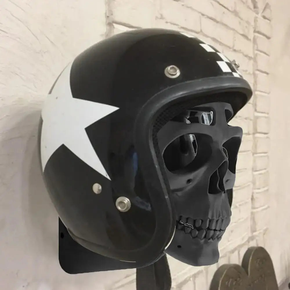 A black helmet with a star design rests elegantly on the Alr™ 3D Skull Motorcycle Helmet Display Rack, concealing a black skull and providing the perfect display for any enthusiast.