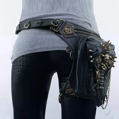 A person is wearing black snake-patterned leggings and a gray sweater, with a Women's Gothic Waist/Hip/Body Fanny Bag featuring spacious compartments, spikes, chains, and gothic-inspired design embellishments.