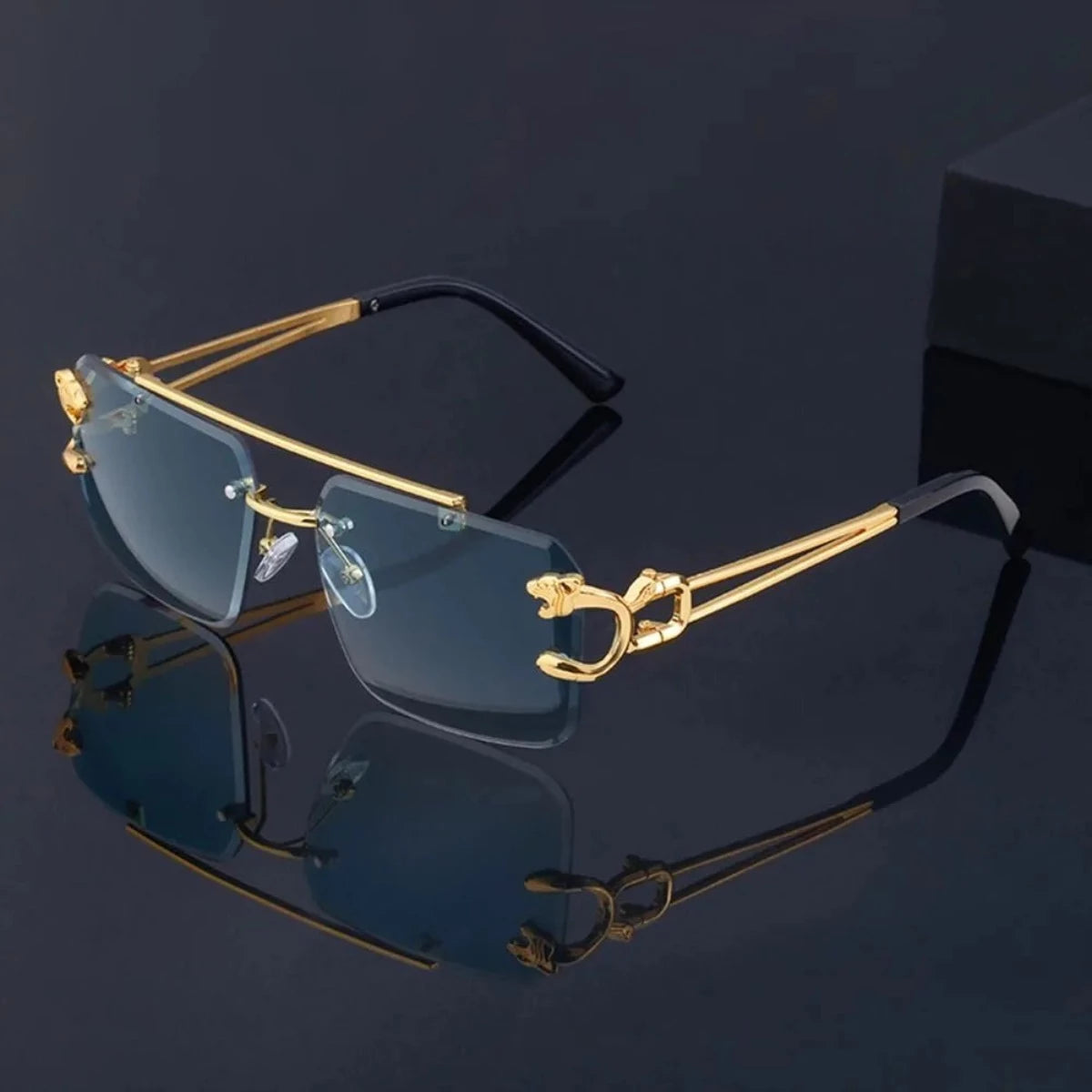 A pair of Retro Rimless Steampunk UV400 Sunglasses with gold rims on a black background.
