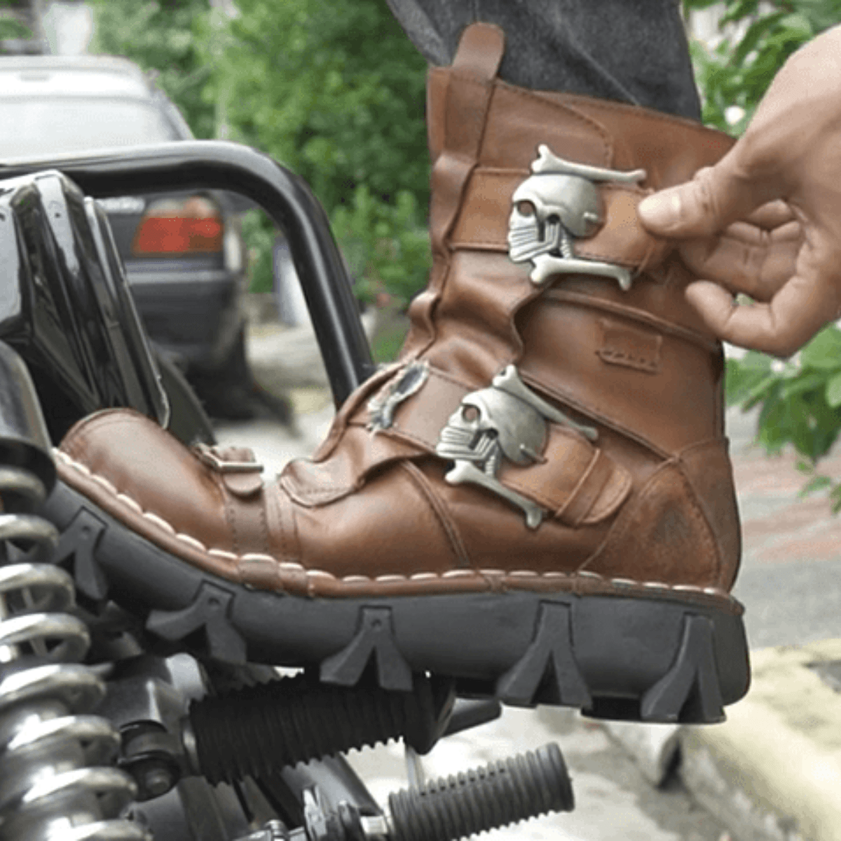 A person is donning Handmade Skull Leather Boots + Free Leg Bag Bundle while riding a motorcycle.