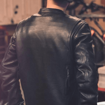 A man wearing a First Manufacturing Raider Leather Jacket made with high-quality naked cowhide leather.