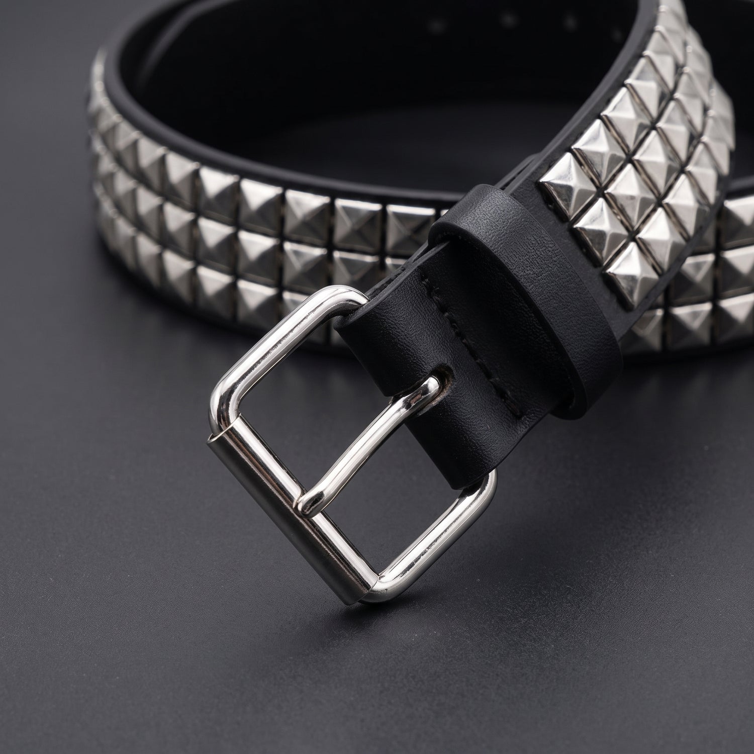 Close up of the roller pin buckle and belt holes on the pyramid studded belt
