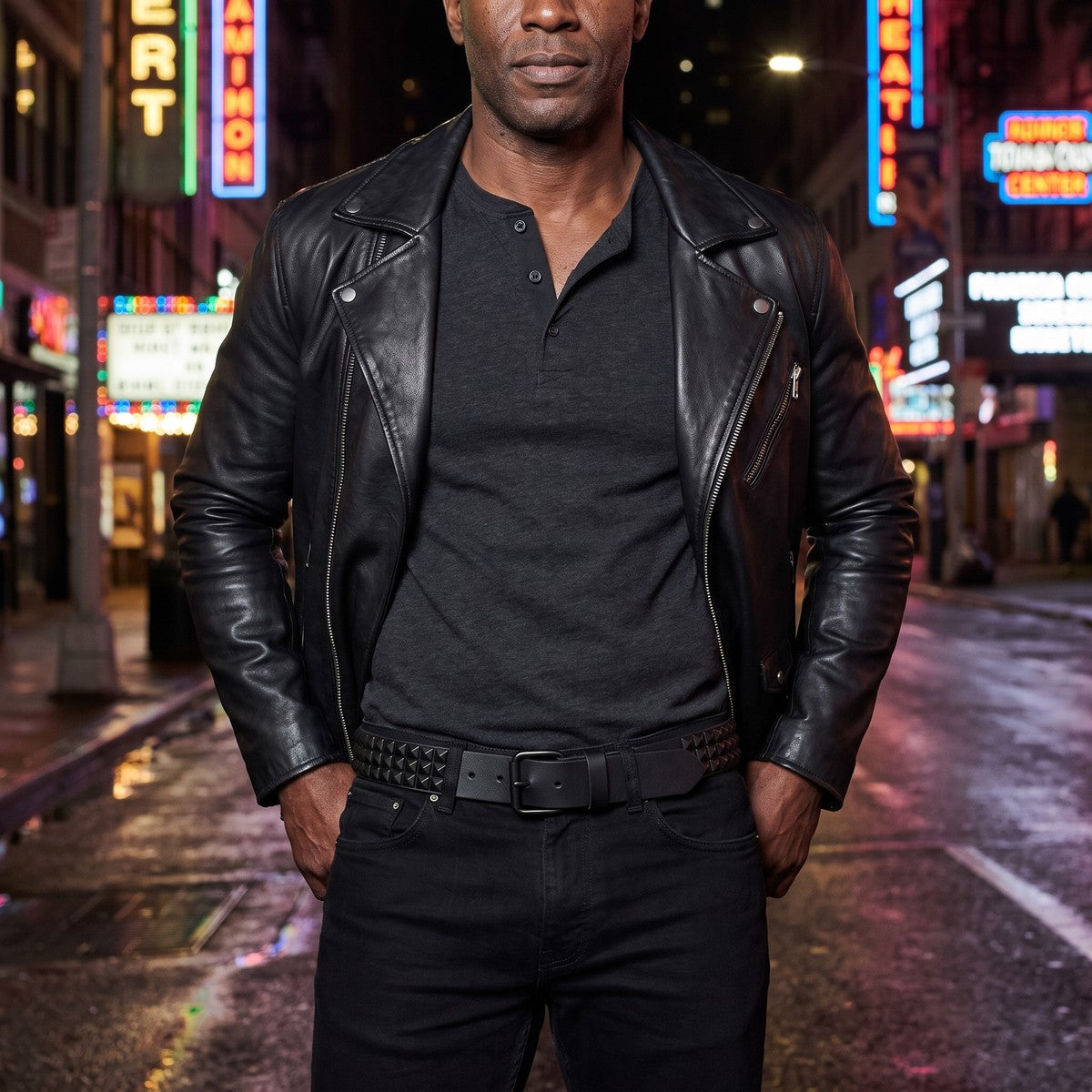 Man wearing the black pyramid studded belt with a leather biker jacket at night
