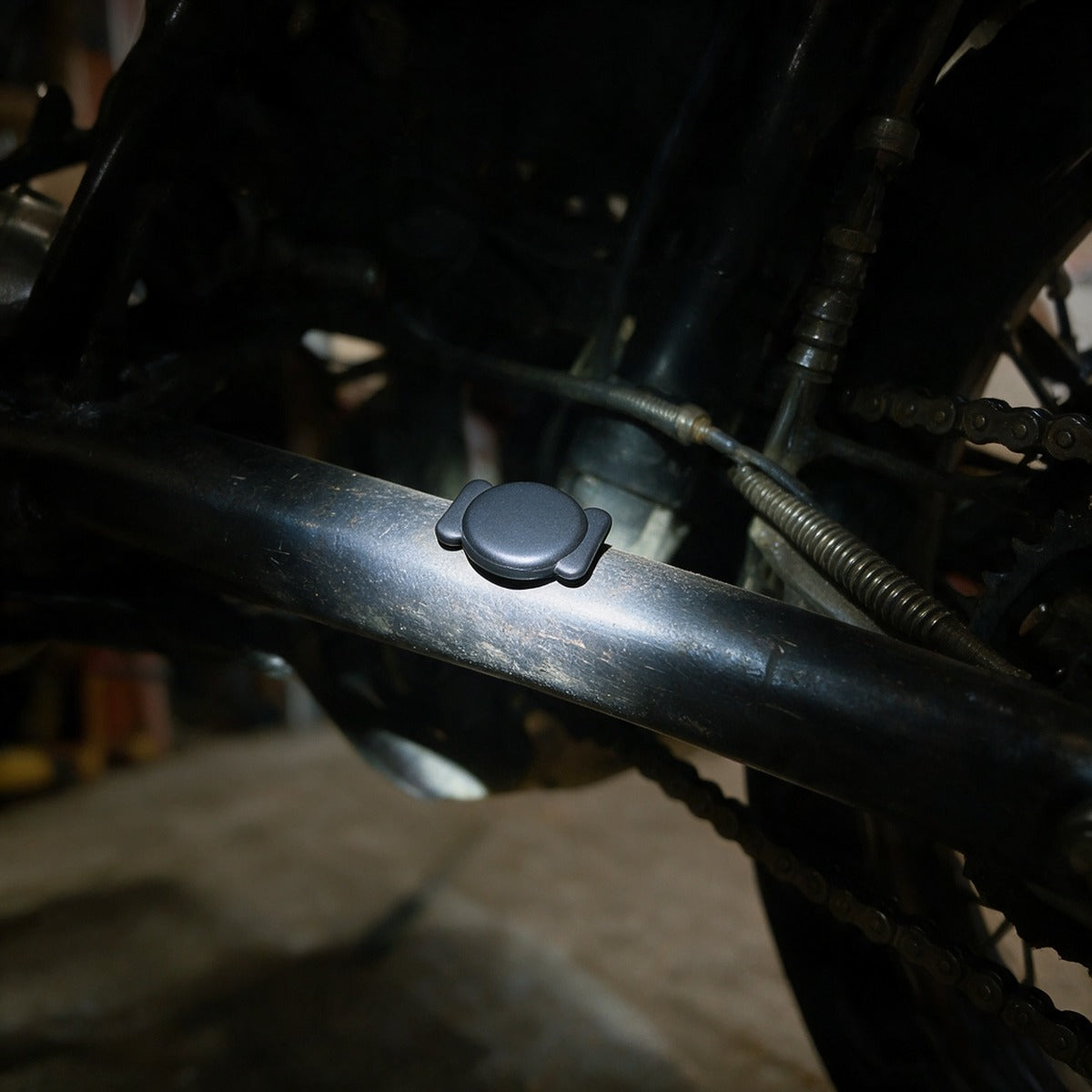 Bluetooth finder tag held magnetically to the frame under a motorcycle