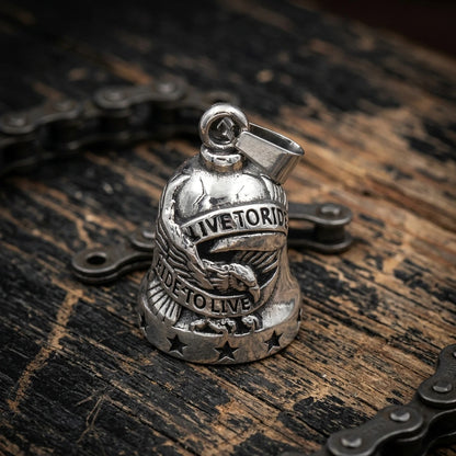 Motorcycle guardian bell Live to Ride silver eagle gremlin bell on wooden table with chain