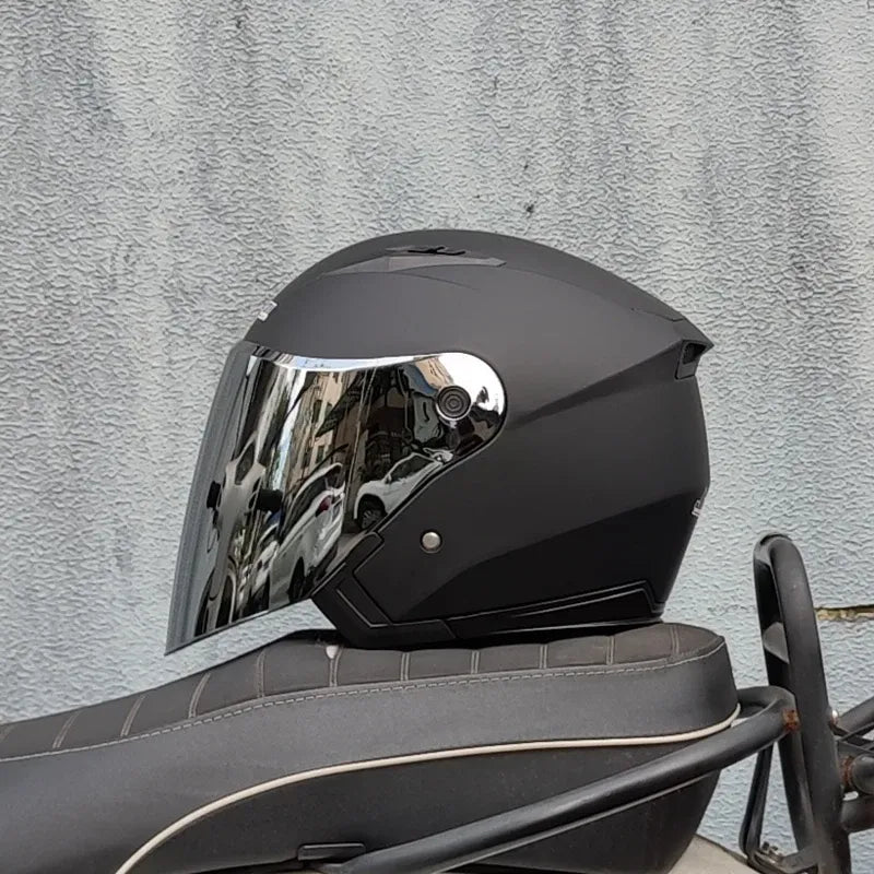 Dual lens motorcycle half helmet in matte black with built in flip down mirrored sun visor