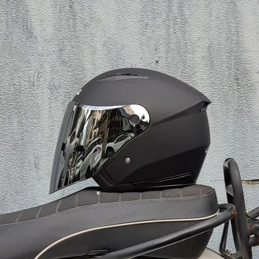 Dual lens motorcycle half helmet in matte black with built in flip down mirrored sun visor